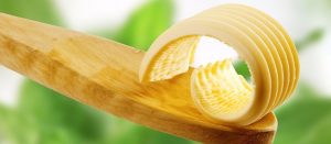 Butter curl on a wooden spoon