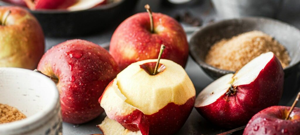 a table topped with bowls of apples and spices